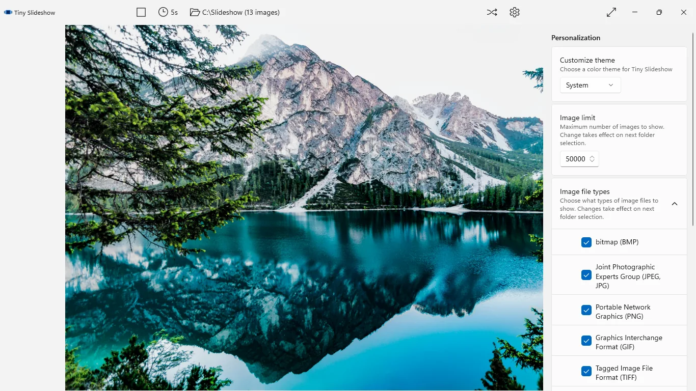 The Personalization panel open beside a mountain lake photo, showing theme, image limit and image file type settings.